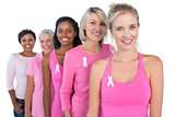 Smiling women wearing pink and ribbons for breast cancer