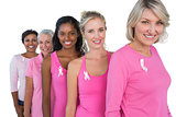 Group of diverse women wearing pink tops and ribbons for breast cance