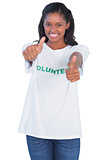 Young woman wearing volunteer tshirt and giving thumbs up