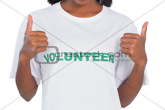 Woman wearing volunteer tshirt and giving thumbs up