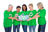 Team of female environmental activists holding box of recyclables