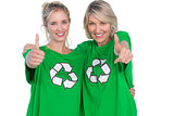 Two smiling women wearing green recycling tshirts giving thumbs up