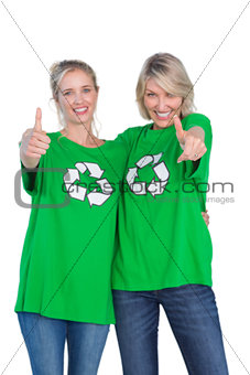Two blonde women wearing green recycling tshirts giving thumbs up