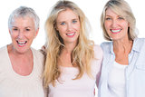 Three generations of  cheerful women smiling at camera