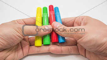 Hands holding pens