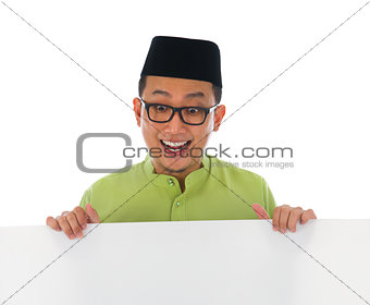 malay male with blank card during hari raya Eid al-Fitr celebrat