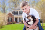 Young Boy and His Dog in Front of House
