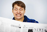 Man shocked by news from the newspaper