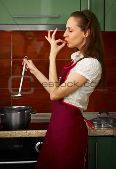 Young housewife on kitchen