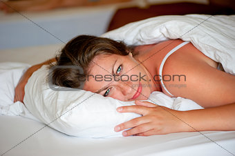 young girl luxuriating in bed the morning