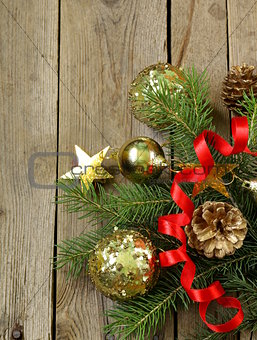 Christmas green fir tree  branches with beautiful decorations on wooden background