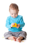 Small baby holding yellow flower