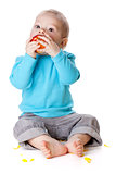 Small baby eating red apple