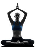 woman exercising yoga meditating sitting hands joined