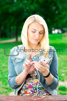 Young blond girl listening player