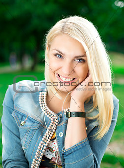 Young blond girl listening player