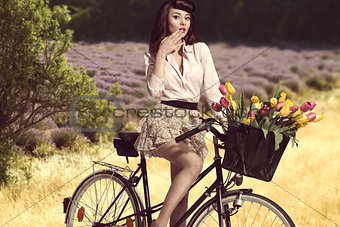 sexy brunette girl on bicycle  in rural outdoor