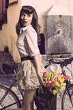 pretty vintage girl near bicycle 