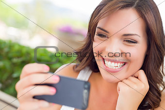 Young Adult Female Texting on Cell Phone Outdoors