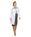 Smiling doctor woman going straight and looking on copy space