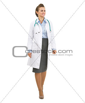 Smiling doctor woman going straight and looking on copy space