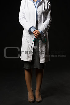 Closeup on doctor woman with stethoscope isolated on black