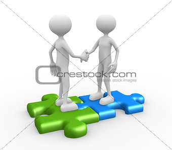  Shaking hands on puzzle pieces