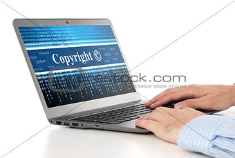 hands typing on laptop. Copyright message concept