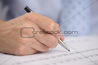 Close-up of business person hand with pen