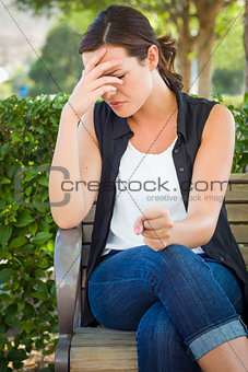 Upset Young Woman Sitting Alone on Bench