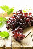 organic ripe black grapes on a wooden table