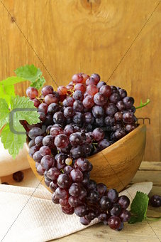 organic ripe black grapes on a wooden table