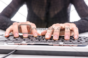 Closeup of a business woman typing on keyboard