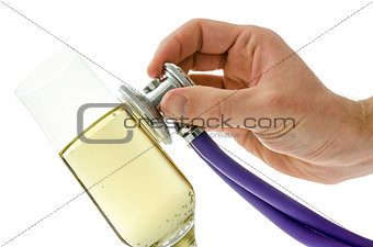 Male hand holding a stethoscope on a glass of wine