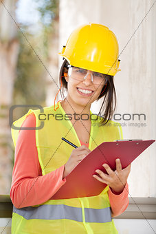 craftswoman holding a notepad and writing