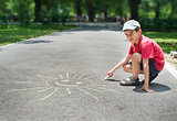 Child drawing on asphalt