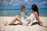Mother and her little daughter at tropical beach