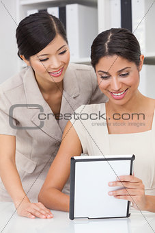 Asian Chinese & Hispanic Businesswomen Using Tablet Computer