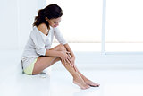 Body care. Woman applying cream on legs