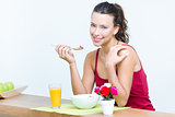 Young woman taking a breakfast cereal at home