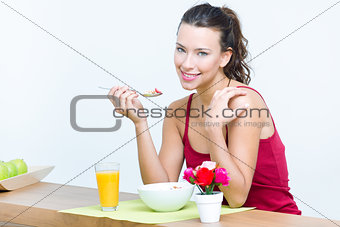 Young woman taking a breakfast cereal at home