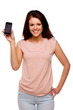 Brunette woman showing the screen of a mobile phone 