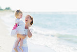 Portrait of smiling mother and baby on beach
