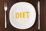 Word diet made of corn seeds on a plate