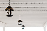 three metal lamps are suspended