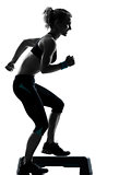 woman exercising step aerobics 