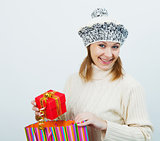 attractive girl in a sweater holding a gift