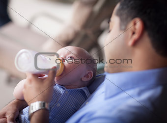 Happy Hispanic Father Bottle Feeding His Mixed Race Son