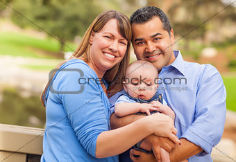 Happy Mixed Race Family Posing for A Portrait Outside
