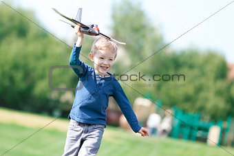 boy playing his toy plane